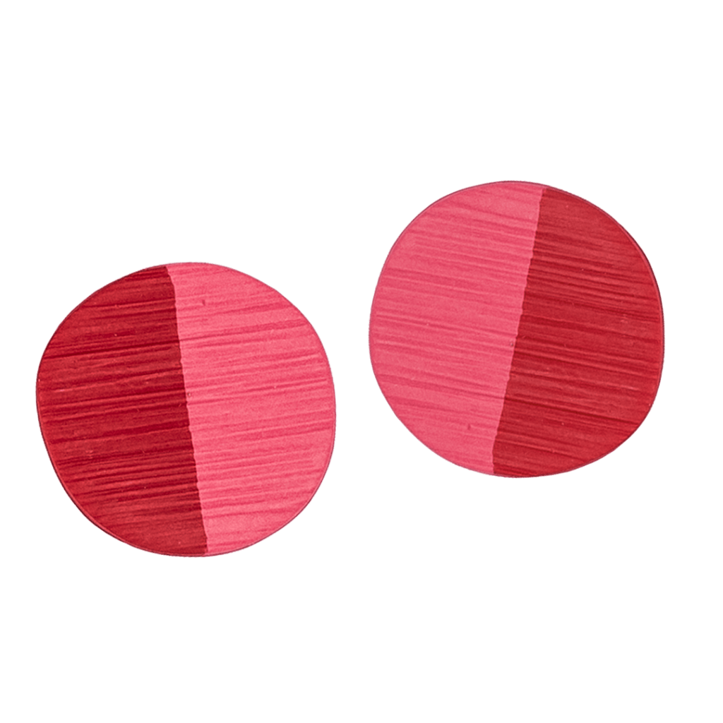 These handcrafted polymer clay earrings by Héloïse Artisanal Jewelry feature a striking auburn and pink color block design. These distinctive quarter-sized studs combine linear texturing with professional elegance. They are perfect for everyday sophisticated style.