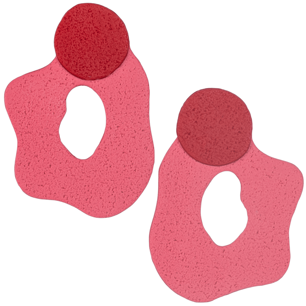 Handcrafted polymer clay statement earrings by Héloïse Jewelry featuring a bold red circle over an organic pink wave. These distinctive pieces combine flowing design with professional sophistication. Perfect for artistic statement style.