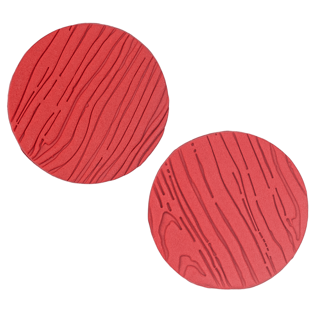 These handcrafted oversized polymer clay earrings by Héloïse Artisanal Jewelry feature rich poppy red and artistic wood-grain texture. These bold 3-inch statement pieces blend dramatic presence with sophisticated design, perfect for a confident professional style.